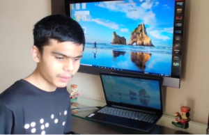Pranav with laptop and projection on television